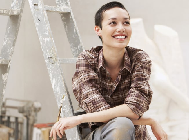 Person sitting on ladder after doing a painting task